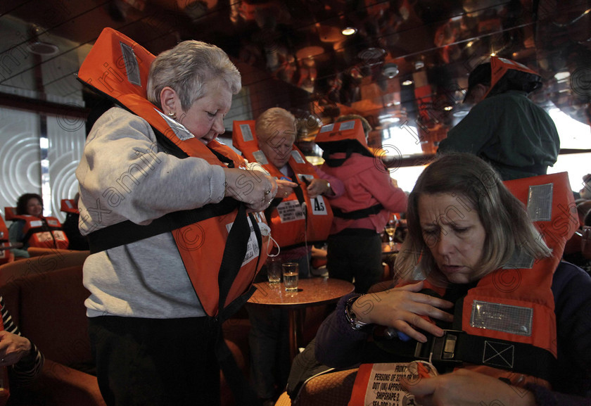 BRITAIN Titanic 42 
 In this photo taken Sunday, April 8, 2012, passengers put on their life jackets during an emergency drill aboard the MS Balmoral Titanic memorial cruise ship, as it sets sail from Southampton, England. A cruise carrying relatives of some of the more than 1,500 people who died aboard the Titanic nearly 100 years ago set sail from England on Sunday to retrace the ship's voyage, including a visit to the location where it sank. (AP Photo/Lefteris Pitarakis)