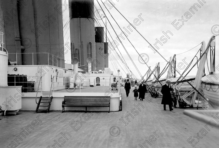 432454 
 Please archive -
In April, 1912 the RMS Titanic called to the port of Queenstown (Cobh) on her maiden voyage. The pride of the White Star Line arrived at Roche's Point at 11.30 a.m. A total of 123 passangers embarked at Queenstown. Three days later the liner struck an iceberg. Of the 2228 passangers and crew aboard only 705 survived. Picture shows passangers strolling along the deck of the doomed liner off Roche's Point. 
Ref.114/115 11/04/1912
Old black and white liners disasters