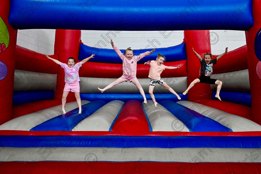 jfj123 
 Summer Camps Stand Alone: 04/07/24
Best friends Maisie Donnellan, Ava Dixon, Carragh Scully and Marlene Smith practice synchronised jumping on the bouncing castle in The Let’s Go Summer camp running in Carrigaline Community School. Picture Chani Anderson