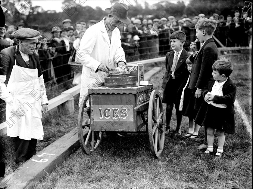 125049 
 PLEASE ARCHIVE:
ICE CREAM SELLER AT SPORTS EVENT 1937. REFRESHMENTS. TRADER. ICE CREAM MAN.
REF: 183C CONES OLD CORK BLACK AND WHITE PICS 99