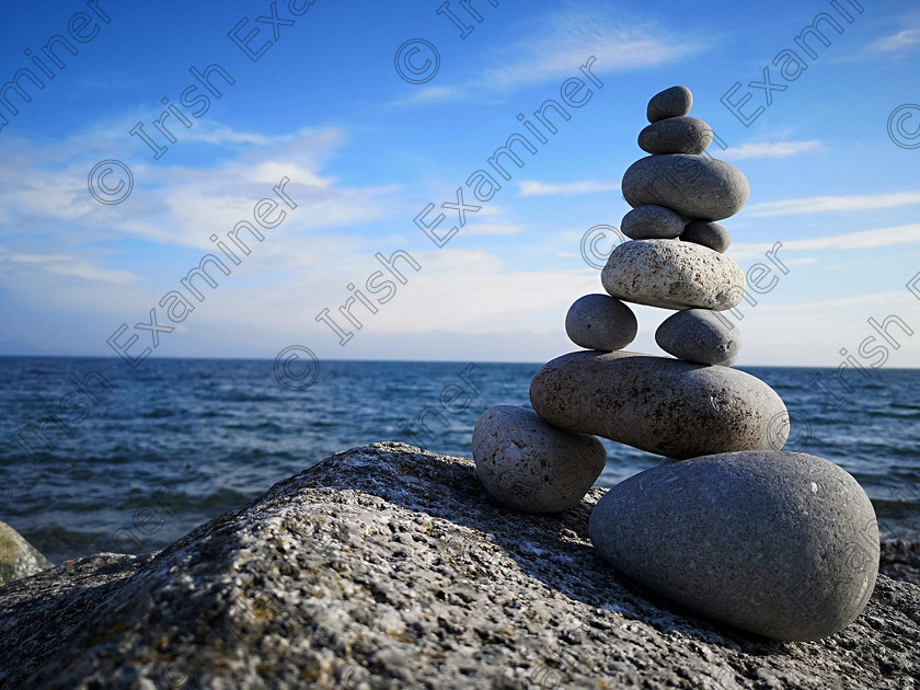 2018-10-06 06-17-08 
 Photo of a stone stack and the sea in the background, taken in Salthill in summer 2018. Photo: Niall Scully