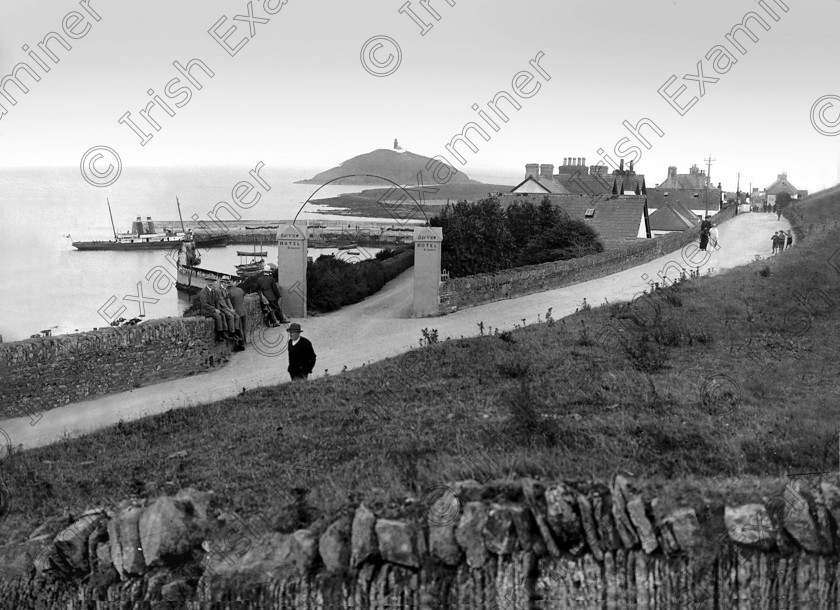 ballycotton 
 View of Ballycotton village, pier and lighthouse in 1929. Note steam powered harbour cruiser tied up at pier. Ref. 177A old black and white