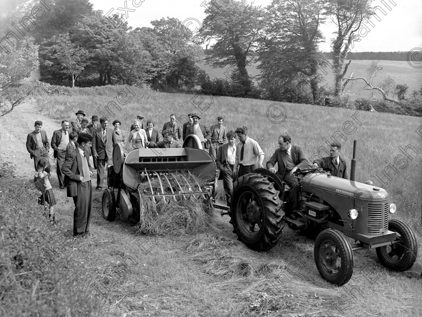 779335 
 Cross and Sons represenattives demonstrating their new bailer to farmers at White's Cross 06/09/1955 Ref. 355H Old black and white farming machinery