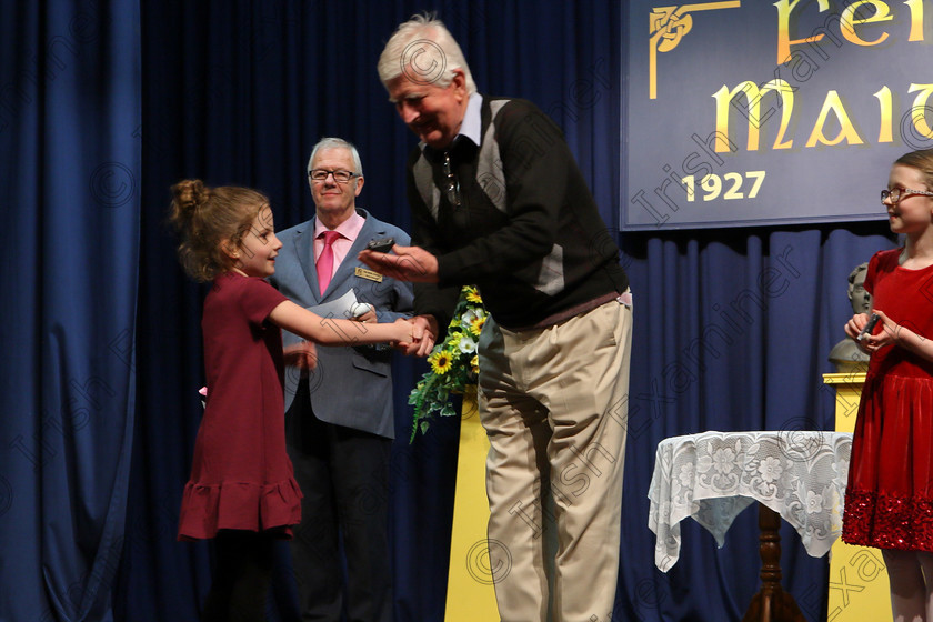 Feis22032018Thu30 
 30
Adjudicator Seán Ó Muineacháin presenting Lily De Barra with her Silver Medal.
 Labhairt na Filíocht agus Míreanna Drámaíochta Class: 517: “Corn Helen” Bhéarslabhairt 7 Bliana D’Aois Nó Faoina Roinn 2 Feis Maitiú 92nd Festival held in Fr. Mathew Hall. EEjob 22/03/2018 Picture: Gerard Bonus