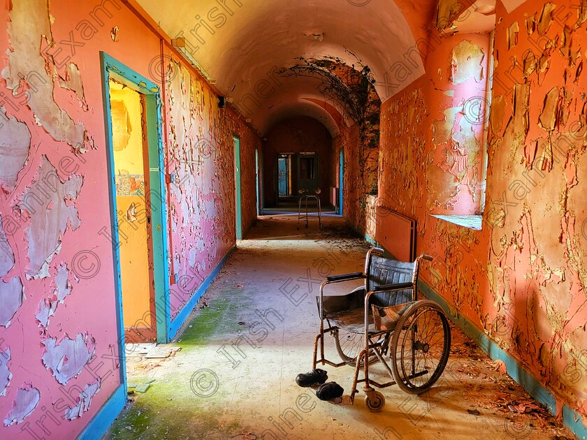 20220817 123947-01 
 A wheelchair sits in the abandoned corridor of Ireland's oldest, forgotten mental institution, St. Brigid's Hospital.