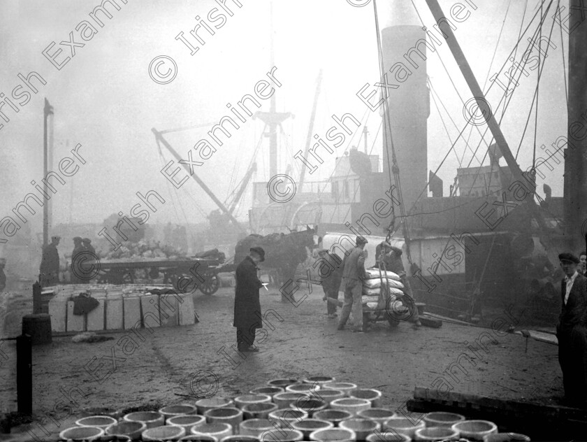 1046688 1046688 
 For 'READY FOR TARK'
A busy docklands scene in winter fog 04/01/1934 Ref. 240B Old black and white weather quays smog