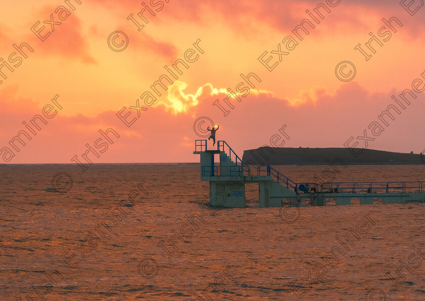 Calendar (1 of 1) 
 I took this photo on the Salthill Prom of a sea swimmer diving off of Blackrock Diving Tower as the sunset behind him during high tide. Salthill, Galway, Co. Galway