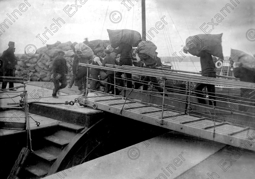 432457 
 While on its maiden voyage the RMS Titanic arrived at Roches Point to pick up passangers and supplies from Queenstown (Cobh). Picture shows supplies being brought aboard the tender PS America.
Ref. 114/115 11/04/1912
Old black and white liners tenders ships