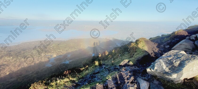 Brocken Spectre Torc Mountain 9 Dec 2024 
 Brocken Spectre taken on top of Torc Mountain, Old Kenmare Road,
Killarney, Co.Kerry. Myself and 2 friends framed inside the Ring of the Sun... a rare phenomenon that happens with winter sun when the sun is at a low point. Ideally you need to be at height in the mountains.

Photographer myself Niamh Quinlan.