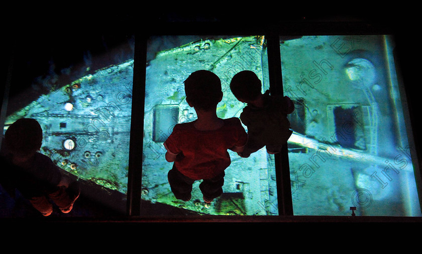 Titanic Belfast Preview 1 0 
 Alan Lewis - PhotopressBelfast.co.uk 27/3/2012
Mandatory Credit - Picture by Justin Kernoghan
The Quinn family from Belfast enjoying the Titanic Belfast building today. Pictured in the cinema room which has a glass floor you stand on and watch aerial photographs and films of the Titanic where it sits at the bottom of the ocean.
Press Release
Opening in March 2012, Titanic Belfast® will be a "must see" visit in any tour of Belfast and Northern Ireland. It is located in the heart of Belfast, on the slipways where RMS Titanic was built.
Inside this iconic building, visitors will re-live the entire Titanic story from her birth in Belfast to the fateful maiden voyage and her eventual discovery on the seabed.
Titanic Belfast® extends over nine galleries, with multiple dimensions to the exhibition, drawing together special effects, dark rides, full-scale reconstructions and innovative interactive features to explore the Titanic story in a fresh and insightful way; from her conception in Belfast in the early 1900s, through her construction and launch, to her infamous maiden voyage and catastrophic demise. The journey goes beyond the aftermath of the sinking, to the discovery of the wreck and continues into the present day with a live undersea exploration centre. 
Further info contact Jonathan King - 028 90339949/07764 627 297 
 Keywords: Alan Lewis 00447850 988920, Justin Kernoghan 00447525 763088, Photopress Belfast