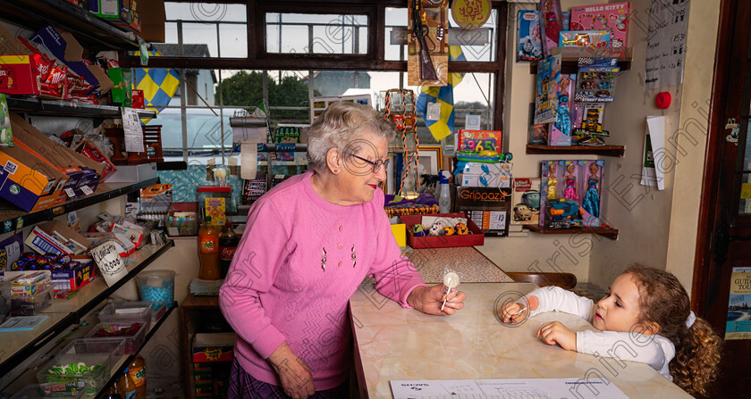 DSC05960-Edit 
 Eileen in her own shop at 82 years old serving her great granddaughter .Photo by Helen Maloney